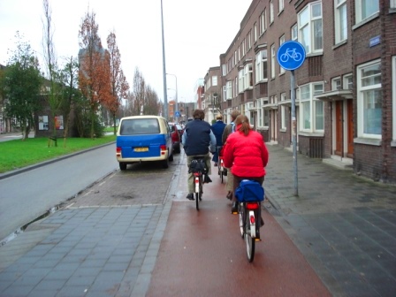 Bike path separated from the roadway via parked cars and medians in Groningen, Netherlands. Image Credit: Zachary Shahan / Bikocity